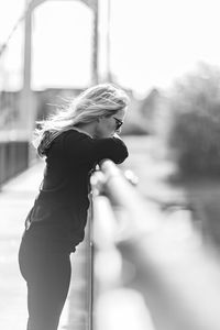 Mature woman standing on bridge