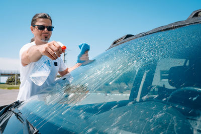 Man washing car windshield