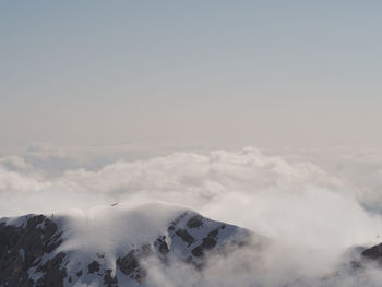 Aerial view of snowcapped mountains against sky