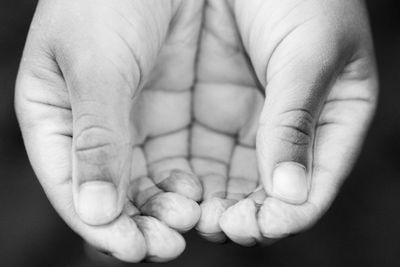 Close-up of hands cupping water