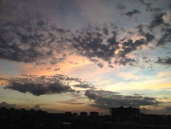 Cityscape against cloudy sky