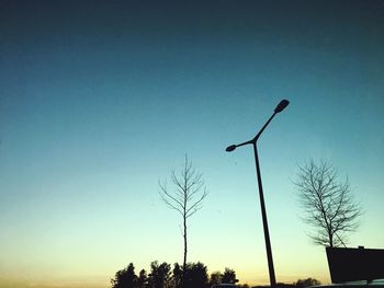 Low angle view of street light against blue sky