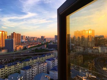 High angle view of cityscape against sky at sunset