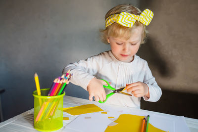 Portrait of boy painting on table