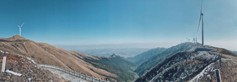 Panoramic view of mountains against blue sky