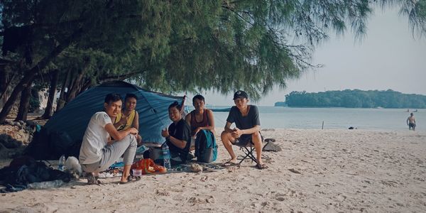 People relaxing on beach