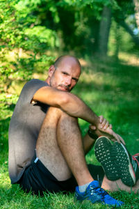 Portrait of young man sitting on land