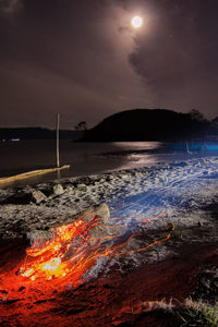 Scenic view of sea against sky at night