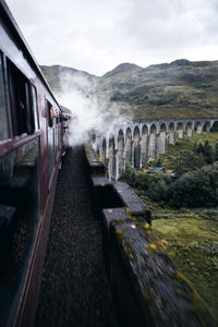 Train on bridge against sky