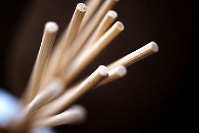 Close-up of piano keys against black background