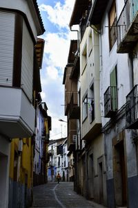 Empty alley amidst buildings in city