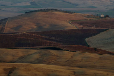 High angle view of road amidst field against sky