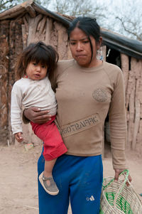Full length of mother and daughter standing outdoors