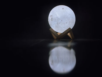 Close-up of light bulb against black background