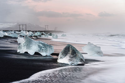 Scenic view of frozen sea against sky during winter