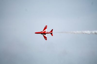 Low angle view of airplane flying against sky