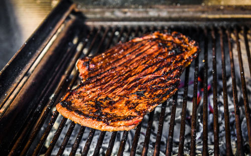 High angle view of meat on barbecue grill