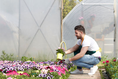 Full length of man working in greenhouse