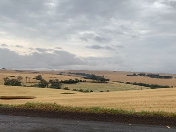 Scenic view of farm against sky