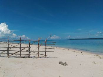 Scenic view of beach against blue sky