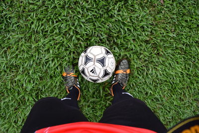 Low section of man standing on grass