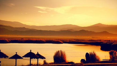 Scenic view of lake at sunset