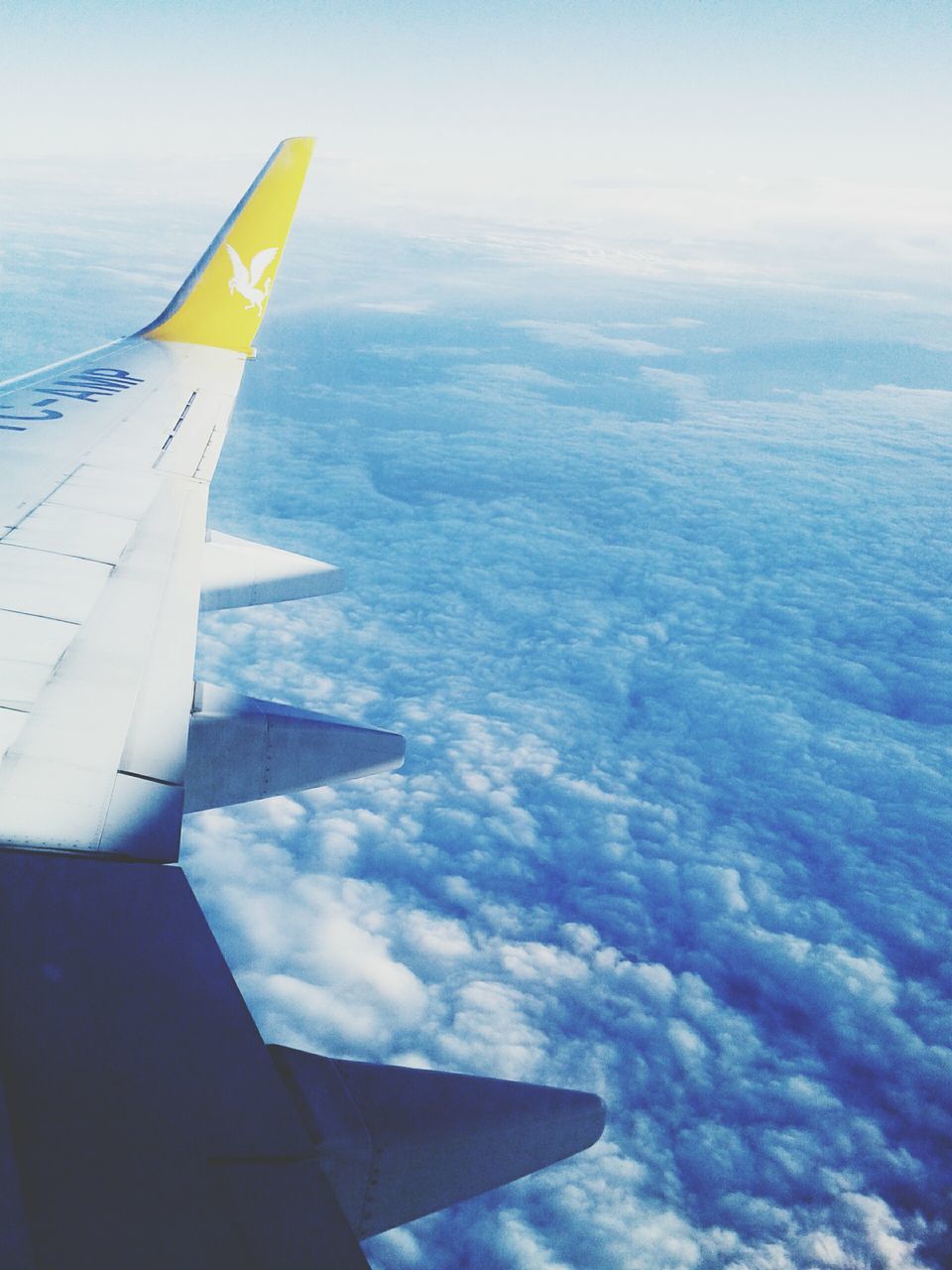 transportation, flying, airplane, mode of transport, aircraft wing, air vehicle, cropped, part of, mid-air, travel, sky, journey, aerial view, scenics, on the move, beauty in nature, nature, cloud - sky, blue, airplane wing