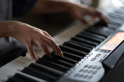 Cropped hand playing piano