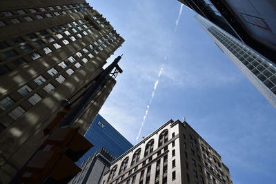 Low angle view of buildings against blue sky