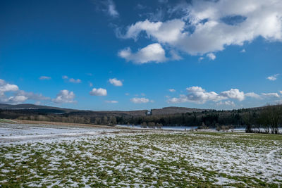 Scenic view of field against blue sky