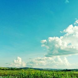 Scenic view of field against cloudy sky