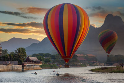 Nam song river at sunset with hot air balloon in vang vieng, laos, beautiful vang vieng, laos.