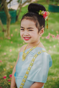 Portrait of cute smiling girl standing in park