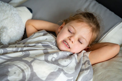 Portrait of cute baby boy sleeping on bed at home