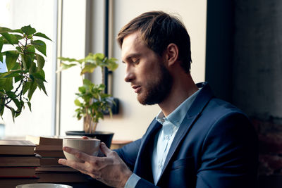 Young man looking at window