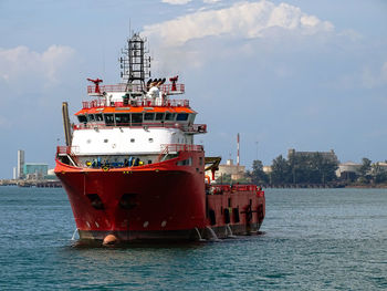 Ship sailing in sea against sky