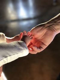 Cropped image of parent touching baby foot