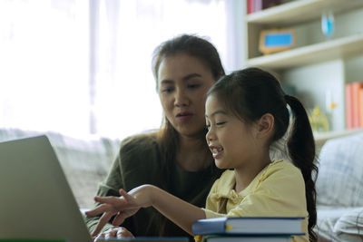 Young woman using laptop at table