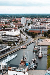 High angle view of buildings by sea against sky