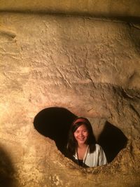 Portrait of smiling woman standing on rock