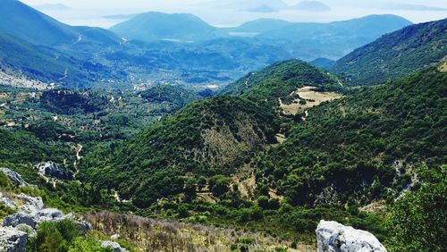 Scenic view of trees and mountains against sky