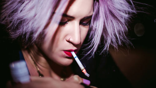 Close-up of young woman smoking cigarette