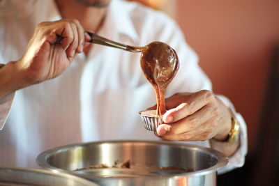 Midsection of man preparing the bakery