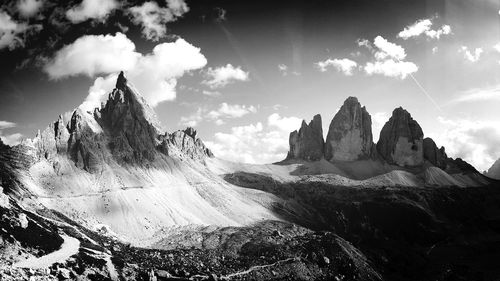 Scenic view of rocky mountains against cloudy sky