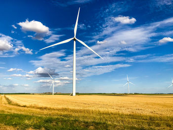 Windmill on field against sky