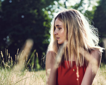 Portrait of young woman looking away outdoors
