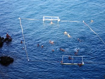 High angle view of men playing water polo in sea