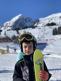 Portrait of child standing on snow covered landscape