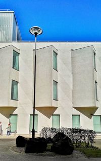 Buildings in city against blue sky