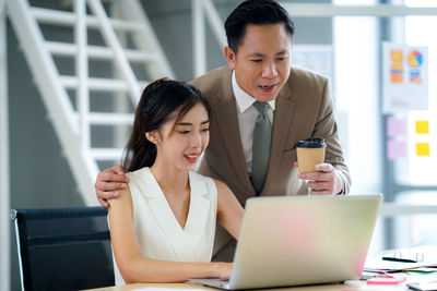 Businesswoman using laptop at office
